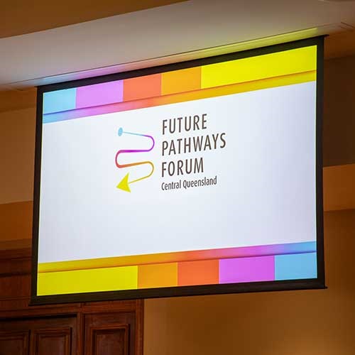 A projector screen in a hall showing the Future Pathways Forum logo